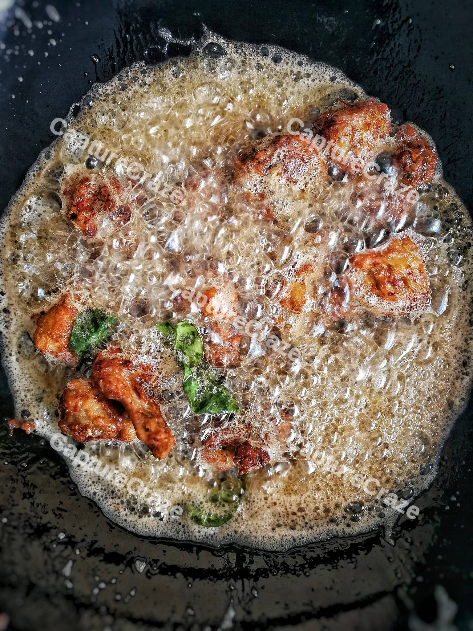 Fried chicken wings in the boiling oil
